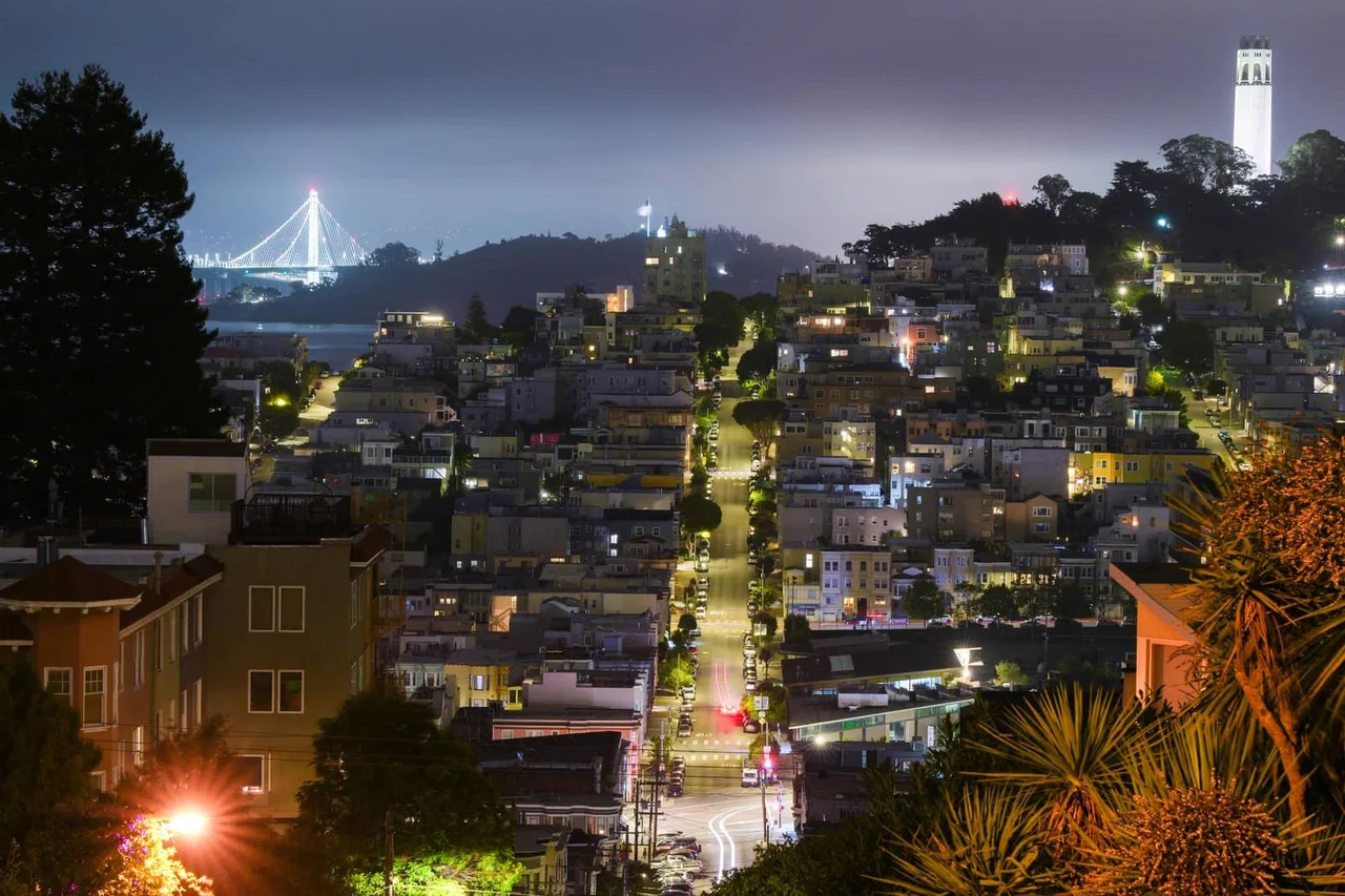 San Francisco at night, with the Bay Bridge and Coit Tower